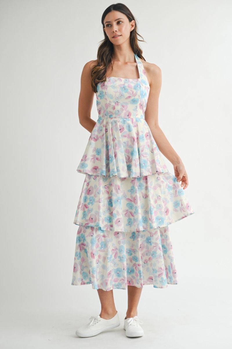 Floral printed halter neckline open back self tie tiered midi dress. Back button closure. Lining.