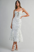 Woven midi dress featuring a sweetheart neckline with adjustable spaghetti straps.