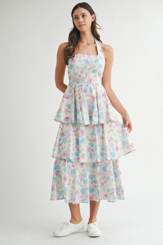 Floral printed halter neckline open back self tie tiered midi dress. Back button closure. Lining.
