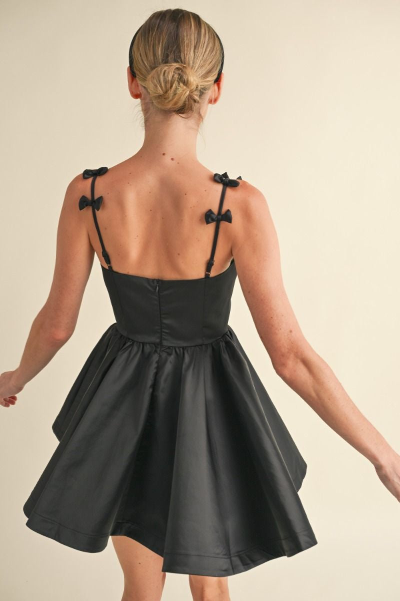 Adjustable spaghetti strap with bow applique detail fit and flare mini dress. Lining. Back invisible zipper