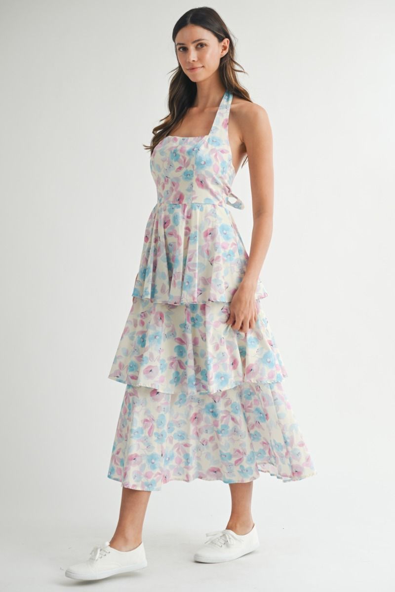 Floral printed halter neckline open back self tie tiered midi dress. Back button closure. Lining.