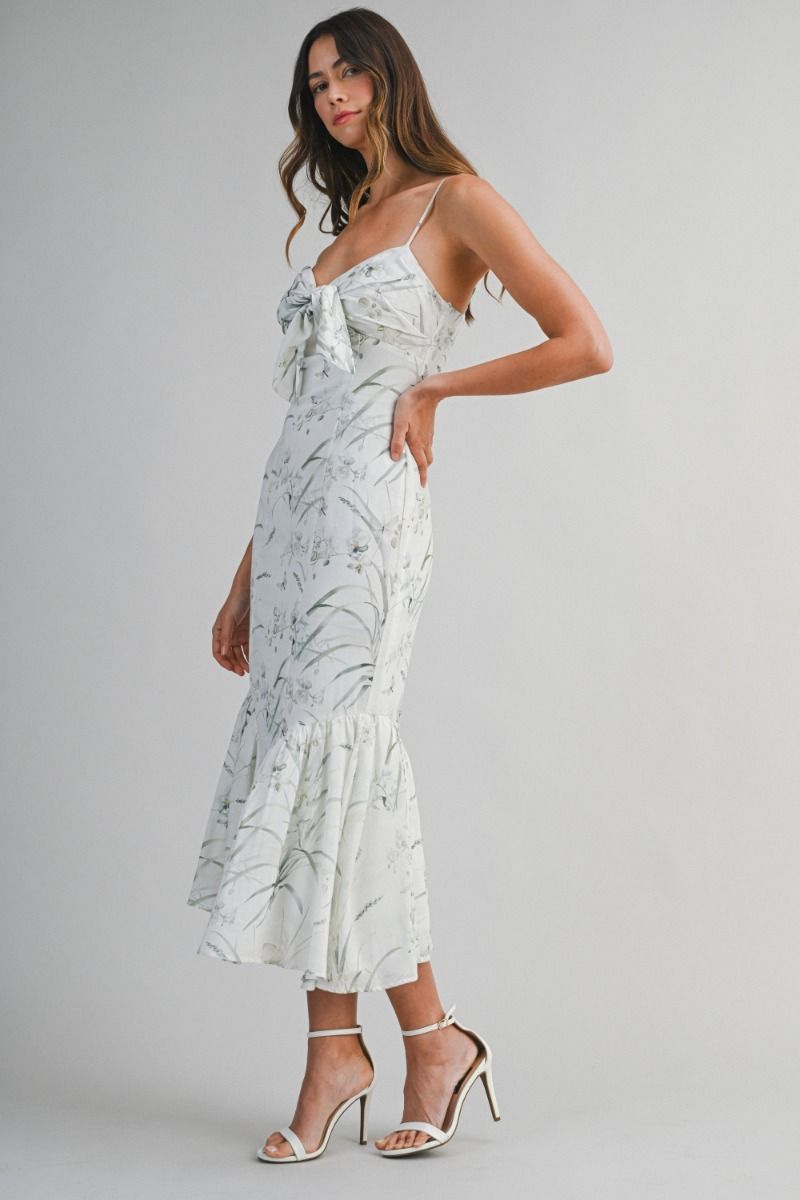 Woven midi dress featuring a sweetheart neckline with adjustable spaghetti straps.