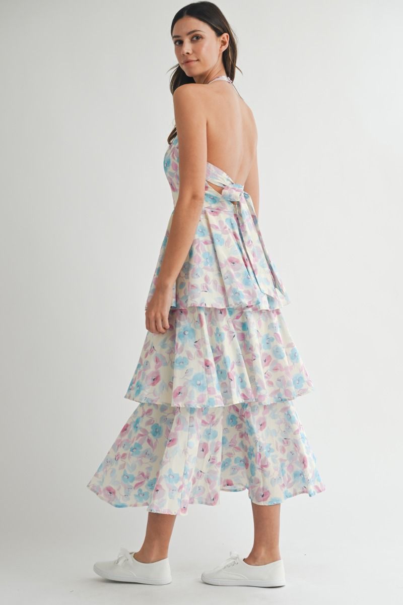 Floral printed halter neckline open back self tie tiered midi dress. Back button closure. Lining.