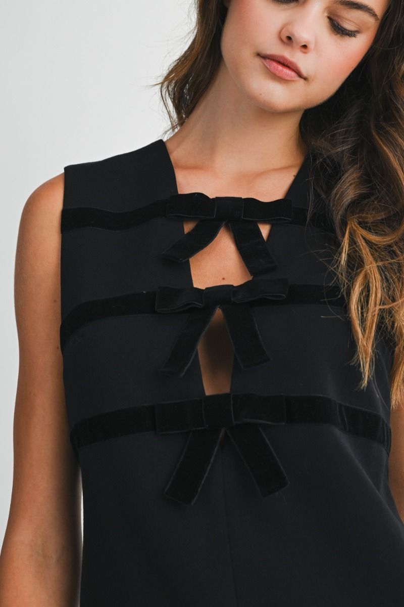 Sleeveless mini dress with round neckline and straight silhouette.