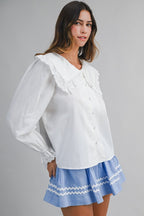 Solid long-sleeve blouse featuring an oversized sailor-style collar with scalloped eyelet lace trim