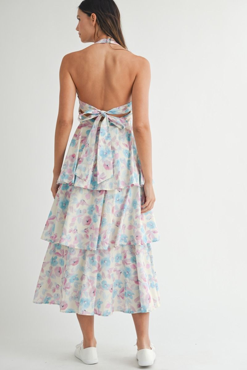 Floral printed halter neckline open back self tie tiered midi dress. Back button closure. Lining.